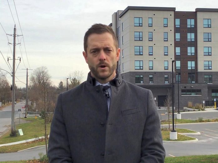 Detective sergeant Josh McGrath in a Peterborough Police Service video describing the incident on November 16, 2024 at the Hunt Terraces apartment building that resulted in the death of a 62-year-old Peterborough man who was a tenant in the building. A 38-year-old Peterborough man who is also a tenant in the building has been charged with second-degree murder. (kawarthaNOW screenshot)