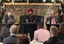 City of Peterborough chief administrative officer Jasmir Raina (middle) addressing the audience at the annual Mayor's Breakfast event at the Peterborough Golf and Country Club on November 21, 2024, presented by the Peterborough and the Kawarthas Chamber of Commerce, as the chamber's vice president of government relations and communications Joel Weibe (left) and Mayor Jeff Leal listen. (Photo: Jeannine Taylor / kawarthaNOW)