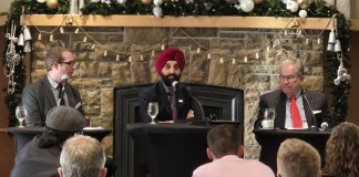 City of Peterborough chief administrative officer Jasmir Raina (middle) addressing the audience at the annual Mayor's Breakfast event at the Peterborough Golf and Country Club on November 21, 2024, presented by the Peterborough and the Kawarthas Chamber of Commerce, as the chamber's vice president of government relations and communications Joel Weibe (left) and Mayor Jeff Leal listen. (Photo: Jeannine Taylor / kawarthaNOW)