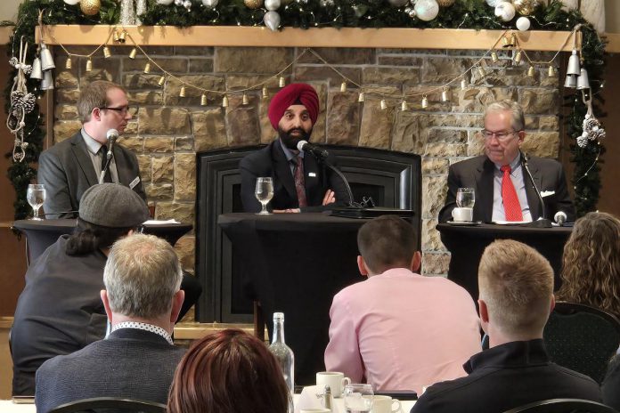 City of Peterborough chief administrative officer Jasbir Raina (middle) addressing the audience at the annual Mayor's Breakfast event at the Peterborough Golf and Country Club on November 21, 2024, presented by the Peterborough and the Kawarthas Chamber of Commerce, as the chamber's vice president of government relations and communications Joel Weibe (left) and Mayor Jeff Leal listen. (Photo: Jeannine Taylor / kawarthaNOW)