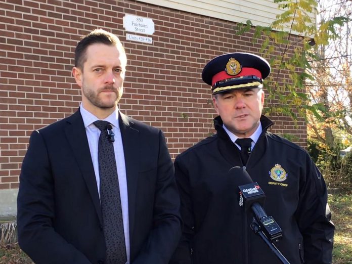 Detective sergeant Josh McGrath and deputy police chief Jamie Hartnett speak to the media on November 13, 2024 at the site of a shooting at 850 Fairbairn Street in Peterborough, where three male suspects fired multiple shots into the townhomes and into the air the previous night. No one was injured in the incident, which police believe is connected to the illicit drug trade. (kawarthaNOW screenshot of police video)