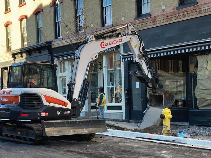 Construction crews tearing up recently poured concrete sidewalks on the south side of Walton Street in downtown Port Hope after footprints were left in the still-curing concrete, part of the Walton Street reconstruction project. The municipality says the damaged sidewalks will either be repaired or removed and repoured and fully cured in time for Port Hope's Christmas celebrations beginning November 29, 2024. (Photo: Municipality of Port Hope)