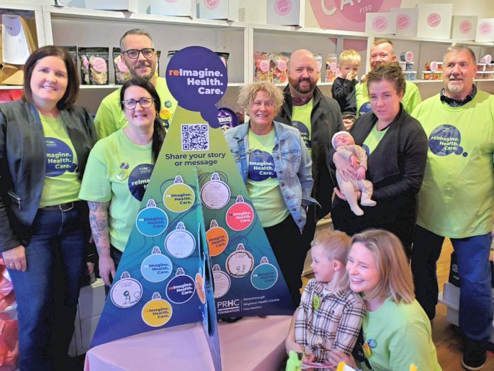 The Sharing Tree, an initiative to connect the community with Peterborough Regional Health Centre (PRHC) during the holiday season in support of the PRHC Foundation's $60-million Campaign for PRHC to reimagine healthcare at the regional hospital, was launched on November 23, 2024 at Couture Candy PTBO in downtown Peterborough. Pictured from left to right are PRHC Foundation president and CEO Lesley Heighway and reImagineers Lisa and Matt Couture, Susan Dunkley, Noah Crowley, Nick Beamish and his son Luke, Jess Crowley and her son Theo, Darryl Porter, and (in front) PRHC Foundation manager of community giving and engagement Jane Lovett with her son Sam. (Photo courtesy of PRHC foundation)