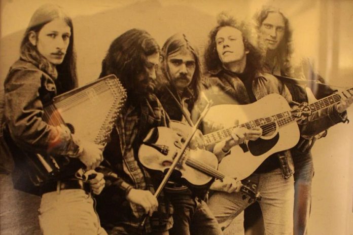 Russell deCarle (right) with The King City Slickers (Bob Wallace, Bernie Jaffe, Iain McIntyre, and Keith Glass) behind the El Mocambo in Toronto circa 1973. deCarle's first performance in Peterborough was with The King City Slickers, and he and Glass went on to form the first iteration of Prairie Oyster in 1974 with steel guitarist Dennis Delorme who was living in Peterborough at the time. (Photo via Reddit)