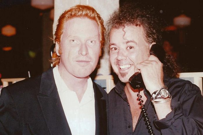 Russell deCarle with the late Peterborough singer-songwriter Willie B. Bennett acting out their co-written song "Goodbye, So Long, Hello", which Bennett initially recorded on his 1989 album "The Lucky Ones" before Prairie Oyster recorded their own version as the first single and hit from their second studio album "Different Kind of Fire" in 1990. (Photo courtesy Larry Delaney Music / Photo Archives)