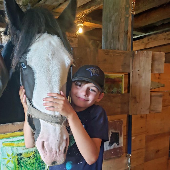 At The Mane Intent, Jennifer Garland, RP works with a range of clients including children, youth, and adults. Equine-assisted psychotherapy can be especially supportive for young people to help them develop emotional regulation, build self-esteem, boost confidence, and learn to read body language and non-verbal cues. (Photo courtesy of The Mane Intent) 