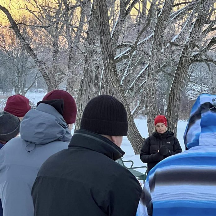 Registered psychotherapist Julie Brown and attendees at a Darkness to Light gathering at Rogers Cove in Peterborough remember those lost to suicide or overdose. Hosted by the Greater Peterborough Health Services Foundation (GPHSF) with support from Seven Hills Developments, the 2024 gathering takes place at sunrise on Saturday, December 21. Guests are encouraged to arrive by 7:30 a.m. (Photo: GPHSF)