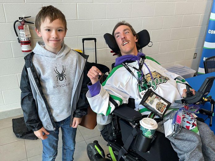 Current Five Counties client Harland (left) and alumnus Nick share a moment before the Cougars for Kids event held at the Cobourg Cougars game in November. Harland and his family got to drop the puck before the game, an honour Nick did the previous year. (Photo courtesy of Five Counties Children's Centre)