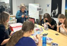 Guest artist Lisa Noble from the Trent University School of Education leads GreenUP Youth Climate Action participants in a workshop activity to create jewellery with recycled parts like bike chains and buttons. The workshop held on November 14, 2024 empowered youth to creatively keep used items out of landfills. Youth who complete four of the six workshops in the series receive a certificate adding a valuable credential to their resume. (Photo: Angela Sundue)