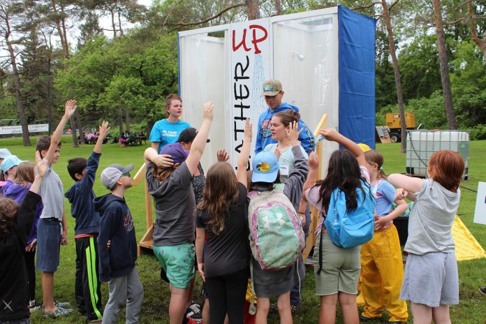 Excited children at the 2024 Peterborough Children's Water Festival volunteer for an opportunity to experience the "Lather Up" activity centre, which teaches students how they and their families can conserve water when showering. The festival is an annual event at the Riverview Park & Zoo that combines education, fun, and hands-on learning to teach children about the importance of water in their lives, empowering them to take action in their homes and communities to conserve and protect water. (Photo: Karen Halley)