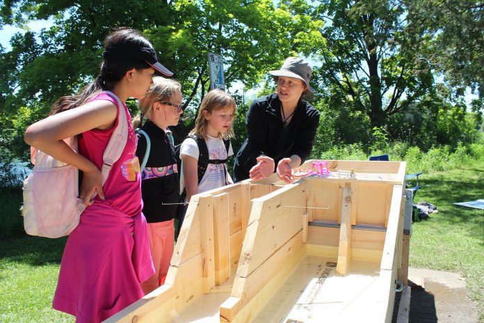 Students at the 2024 Peterborough Children's Water Festival engage in "Leveraging the Locks", a new activity centre by educator Mary Elizabeth Conrad (pictured) featuring an interactive model of a canal lock, demonstrating their function and importance to communities along the Trent-Severn Waterway. (Photo: Karen Halley)