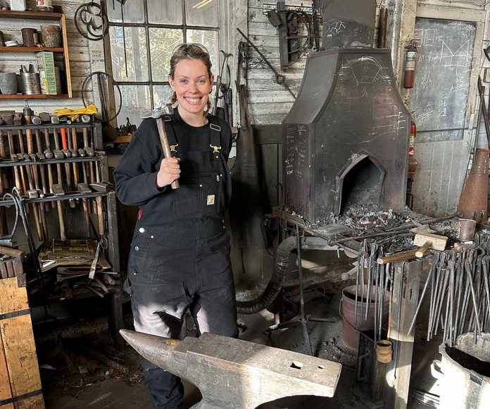 After more than 20 years as a volunteer and employee at Lang Pioneer Village Museum in Keene, museum operations coordinator Hailey Doughty discovered she is a descendent of Daniel Kidd, the blacksmith who worked in and built the blacksmith shop currently at the living history museum. The discovery inspired Doughty to take a blacksmith workshop alongside her father, which has ignited a new passion for the trade among the family's current generation. (Photo courtesy of Hailey Doughty)