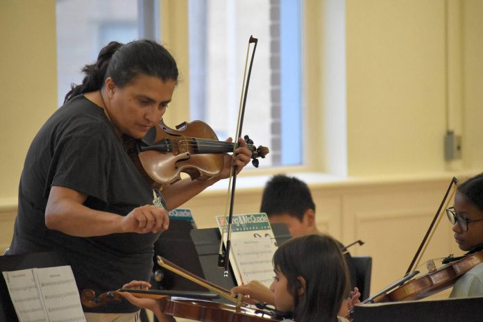 Young musicians in the Kawartha Youth Orchestra's Upbeat! after-school program will perform a "Carol of the Bells" recital on December 12, 2024 at All Saints Anglican Church in Peterborough. Admission is by donation, with proceeds supporting the fully subsidized program for children and youth aged eight to 14 who face barriers to music education. (Photo: Kawartha Youth Orchestra / Facebook)