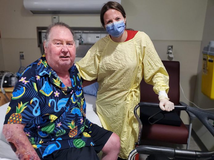 After several consecutive readmissions to hospital, patient Jeff (left) expressed how glad he is to have the support of the Reactivation Care Centre team, including occupational therapist Beth Morgan (right), and a comprehensive plan that includes the use of specialized technology funded by donors to help him achieve the mobility he needs to return home to his family. He feels that he's now on his way to regaining the strength and confidence to live more independently, take part in family activities and help out with some of his favourite chores on their farm. (Photo courtesy of PRHC Foundation)