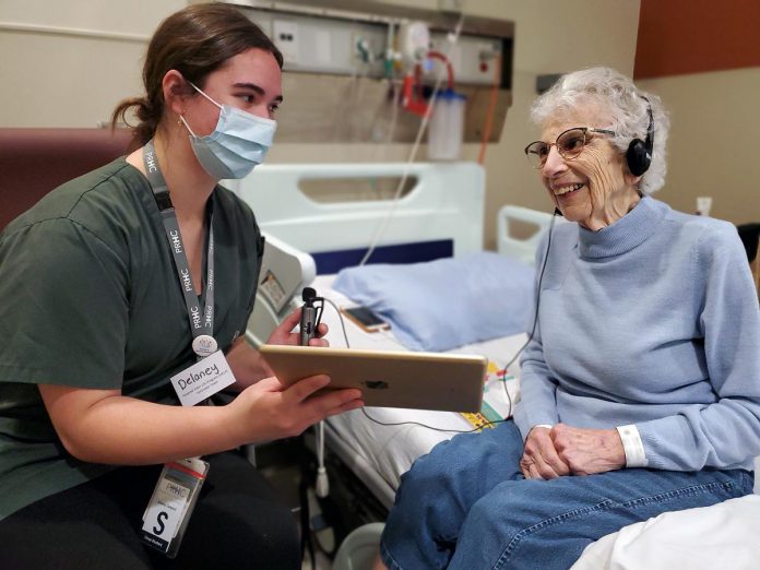 High school student Delaney Campbell (left) is completing her cooperative education placement in the new Reactivation Care Centre through PRHC's Hospital Elder Life Program (HELP). Under HELP, students and other volunteers spend time with Reactivation Care Centre patients like Flo (right). The Reactivation Care Centre takes a seniors care-focused and goal-oriented approach. The unit follows the "4Ms" framework which outlines key considerations for high-quality elderly care, including medication, mobility, what matters, and mentation. Patients will have their own say in focusing on the functional goals that matter to them most. (Photo courtesy of PRHC Foundation)