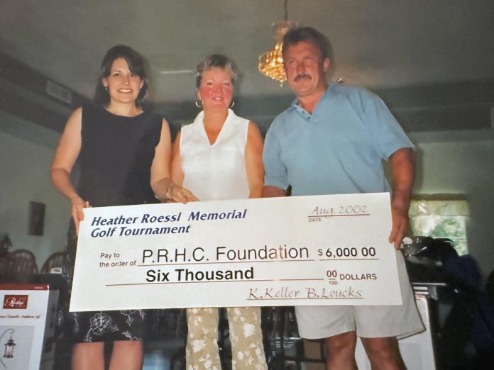 Franz Roessl (right) with a $6,000 cheque to the Peterborough Regional Health Centre (PRHC) Foundation in 2002 after the third annual golf tournament in honour of his late wife Heather Roessl. Over more than two decades, the annual tournament has raised almost $300,000 for the regional hospital. (Photo courtesy of Franzie Roessl)