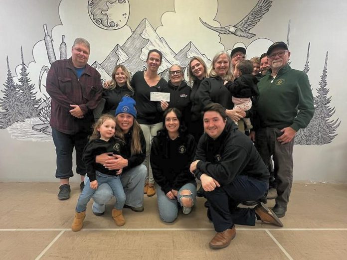 Roter's Reach Mental Health Awareness, an organization launched in 2023 by the family of the late Eric Roter, has donated $15,000 to Right to Heal PTBO. Pictured are Right to Heal PTBO's Liz Shaughnessy-Rowe (holding the cheque) beside Peggy Shaughnessy with members of Eric's family. (Photo courtesy of Haley Scriver)