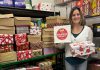 Lindsay Community Food Market coordinator Ashley Anderson with some of the 50 gift-filled shoeboxes distributed to Kawartha Lakes Food Source by The Shoebox Project's Kawartha Lakes chapter for women in the Kawarthas region who are experiencing poverty or homelessness. Thanks to gift donors and sponsors, the Kawartha Lakes chapter of The Shoebox Project for Women collected and delivered 210 gift-filled shoeboxes for the 2024 holiday season. (Photo courtesy of The Shoebox Project Kawartha Lakes)