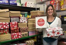 Lindsay Community Food Market coordinator Ashley Anderson with some of the 50 gift-filled shoeboxes distributed to Kawartha Lakes Food Source by The Shoebox Project's Kawartha Lakes chapter for women in the Kawarthas region who are experiencing poverty or homelessness. Thanks to gift donors and sponsors, the Kawartha Lakes chapter of The Shoebox Project for Women collected and delivered 210 gift-filled shoeboxes for the 2024 holiday season. (Photo courtesy of The Shoebox Project Kawartha Lakes)