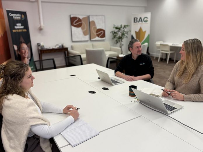 Community Futures Peterborough executive director Devon Girard (right) with loans manager Braden Clark and financial administrator and program officer Abby Keenan meeting in the Business Advisory Centre's new advisory suite in the renovated basement level of Venture North in downtown Peterborough. (Photo courtesy of Community Futures Peterborough)