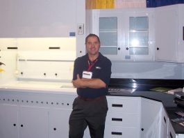 GreenUp executive director Tegan Moss's father Ric Moss, pictured with a display of custom fabricated laboratory equipment he built while working for TFI Inline circa 1998, earned his living and supported his family as a plastic fabricator. (Photo courtesy of Tegan Moss)