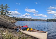 A canoe loaded with back country camping gear is pictured on Cloudy Lake in Kawartha Highlands Provincial Park. While GreenUP executive director Tegan Moss is grateful that reusable plastic food barrel enables her to comfortably camp in the back country, she recognizes that plastic's incredible versatility and durability come with a heavy cost. (Photo: Tegan Moss)