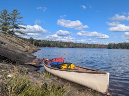 A canoe loaded with back country camping gear is pictured on Cloudy Lake in Kawartha Highlands Provincial Park. While GreenUP executive director Tegan Moss is grateful that reusable plastic food barrel enables her to comfortably camp in the back country, she recognizes that plastic's incredible versatility and durability come with a heavy cost. (Photo: Tegan Moss)