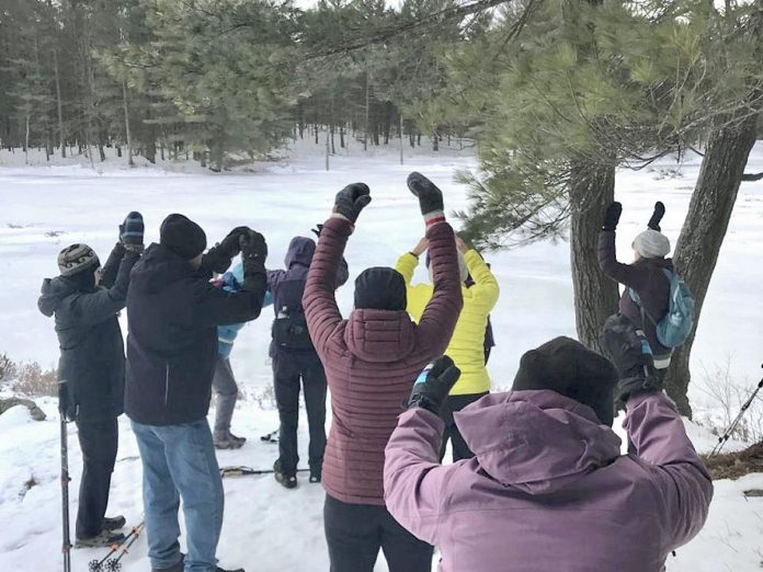 Volunteer hike leader Marcia Mandel led a heart-opening qigong while guiding a group of hikers during a past winter edition of Hike Haliburton. She will once again be leading the Crane Lake Cleanse meditative hike on February 2, 2025 at 10 a.m. in Queen Elizabeth ll Wildlands Provincial Park. (Photo courtesy of Marcia Mandel)