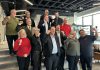 The inductees of Junior Achievement of Northern and Eastern Ontario's 10th annual Peterborough Business Hall of Fame, pictured in the lobby of the Venture North Building in downtown Peterborough on January 22, 2025, are (from left to right, bottom to top) Diane Richard, Nancy Wiskel, Matt Holmes, Michael Riseley, Kelly and Martin Carbajal, Darrell Junkin, Grant Seabrooke, Raj Patel, Micheal Eatson, Eric Eatson, Graeme Eatson, and Drew Merrett. Not pictured: Toni and Kelli Grady, Margo and Paul Hudson, and Donnell Leahy, Natalie McMaster, and Julia Leahy. (Photo courtesy of JA-NEO)