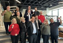 The inductees of Junior Achievement of Northern and Eastern Ontario's 10th annual Peterborough Business Hall of Fame, pictured in the lobby of the Venture North Building in downtown Peterborough on January 22, 2025, are (from left to right, bottom to top) Diane Richard, Nancy Wiskel, Matt Holmes, Michael Riseley, Kelly and Martin Carbajal, Darrell Junkin, Grant Seabrooke, Raj Patel, Micheal Eatson, Eric Eatson, Graeme Eatson, and Drew Merrett. Not pictured: Toni and Kelli Grady, Margo and Paul Hudson, and Donnell Leahy, Natalie McMaster, and Julia Leahy. (Photo courtesy of JA-NEO)