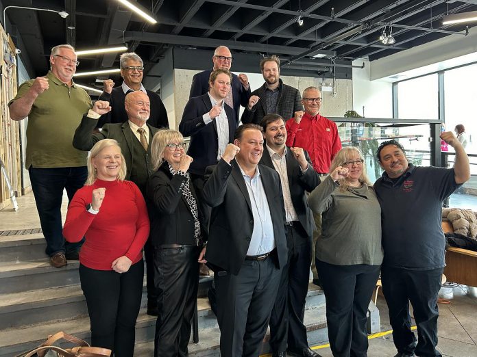 The inductees of Junior Achievement of Northern and Eastern Ontario's 10th annual Peterborough Business Hall of Fame, pictured in the lobby of the Venture North Building in downtown Peterborough on January 22, 2025, are (from left to right, bottom to top) Diane Richard, Nancy Wiskel, Matt Holmes, Michael Riseley, Kelly and Martin Carbajal, Darrell Junkin, Grant Seabrooke, Raj Patel, Micheal Eatson, Eric Eatson, Graeme Eatson, and Drew Merrett. Not pictured: Toni and Kelli Grady, Margo and Paul Hudson, and Donnell Leahy, Natalie McMaster, and Julia Leahy. (Photo courtesy of JA-NEO)