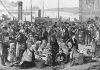 An 1874 engraving published in The Illustrated London News shows Irish emigrants preparing to leave the Queenstown port in County Cork, Ireland for North America. (Public domain image)