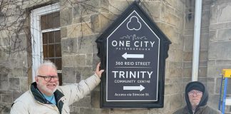 New volunteer-created signage at One City Peterborough, a non-profit charitable organization located in the former Trinity United Church at 360 Reid St. in Peterborough, where it operates the municipally funded Trinity Community Centre, a minimum-barrier space with a daytime drop-in program and overnight program for people who are marginalized or unsheltered. (Photo: One City Peterborough / Facebook)