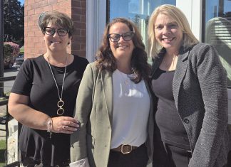 Peterborough County's economic development and tourism team (Tracie Bertrand, Rhonda Keenan, and Sarah Budd) pictured in September 2024 in front of the county's business information hub located in the former post office at 12 Queen Street in downtown Lakefield. The office serves as the central hub in a "hub and spoke" model that will provide services to businesses and residents across the county. (Photo: Peterborough County)