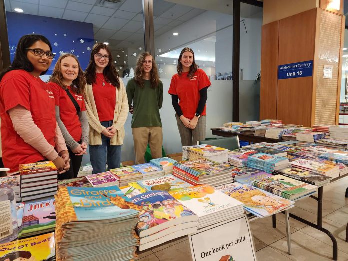 Volunteers managing the book giveaway at Peterborough Family Literacy Day at Peterborough Square in January 2023. Every child who attends the annual event, which returns to Peterborough Square on January 25, 2025 from 10 a.m. to 1 p.m., can take home a free book of their own choosing. (Photo: Peterborough Family Literacy Day / Facebook)