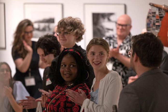 The opening reception for "Figuring Identity", an exhibition of work from participants in the 2024 Youth Art Mentorship Program. The program is led by Dr. Spencer J. Harrison (back right), an educator with OCAD University whose paintings and installation-based artworks have been exhibited internationally. (Photo courtesy of Art Gallery of Peterborough)