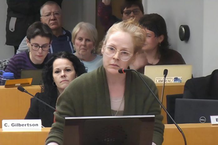 Sarah McNeilly reacts as councillor Lesley Parnell, who was chairing a public meeting under the Planning Act on February 24, 2025, tells her she is not allowed to speak to Mayor Jeff Leal's use of his strong mayor powers to expedite Brock Mission's proposed transitional housing project. (kawarthaNOW screenshot of City of Peterborough video)