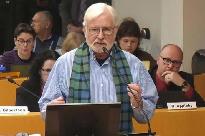 Brock Mission board member Alan Wilson, who is leading the project to develop a 52-unit, six-storey co-ed transitional housing apartment building to be constructed at 738 Chemong Road, speaks to city council during a general committee meeting on February 24, 2025. (kawarthaNOW screenshot of City of Peterborough video)