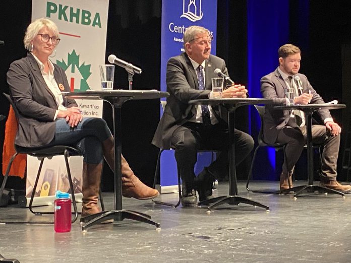 NDP candidate Jen Deck, Progressive Conservative candidate Dave Smith, and Green Party candidate Lucas Graham on the Market Hall stage for a debate on February 18, 2025. Liberal candidate Adam Hopkins was unable to attend the debate due to a personal family matter, and New Blue Party candidate Andrew Roudny was ineligible to participate in the debate as his party has no standing in the provincial legislature, but was allowed to make a statement. (Photo: Paul Rellinger / kawarthaNOW)