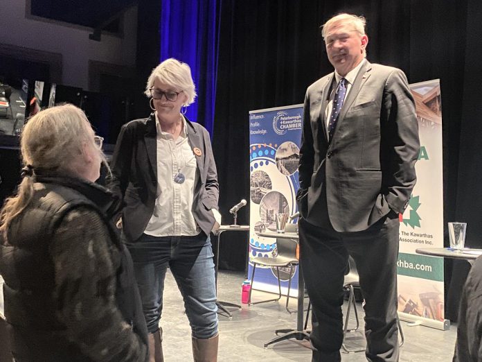 NDP candidate Jen Deck and PC candidate and incumbent MPP Dave Smith chat with "Washboard" Hank Fisher after a debate at Market Hall in downtown Peterborough on February 18, 2025. (Photo: Paul Rellinger / kawarthaNOW)