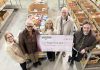 Kawartha Food Share general manager Ashlee Aitken (third from left) accepts a $12,001.77 cheque from (left to right) City of Peterborough parking operations supervisor Lynn Todd, Town Ward councillor Joy Lachica, Bill Wolfe of Wolfe Personal Injury Lawyers, and Town Ward councillor Alex Bierk at Kawartha Food Share's warehouse at 665 Neal Drive on February 12, 2025. (Photo courtesy of City of Peterborough)