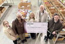 Kawartha Food Share general manager Ashlee Aitken (third from left) accepts a $12,001.77 cheque from (left to right) City of Peterborough parking operations supervisor Lynn Todd, Town Ward councillor Joy Lachica, Bill Wolfe of Wolfe Personal Injury Lawyers, and Town Ward councillor Alex Bierk at Kawartha Food Share's warehouse at 665 Neal Drive on February 12, 2025. (Photo courtesy of City of Peterborough)