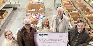 Kawartha Food Share general manager Ashlee Aitken (third from left) accepts a $12,001.77 cheque from (left to right) City of Peterborough parking operations supervisor Lynn Todd, Town Ward councillor Joy Lachica, Bill Wolfe of Wolfe Personal Injury Lawyers, and Town Ward councillor Alex Bierk at Kawartha Food Share's warehouse at 665 Neal Drive on February 12, 2025. (Photo courtesy of City of Peterborough)