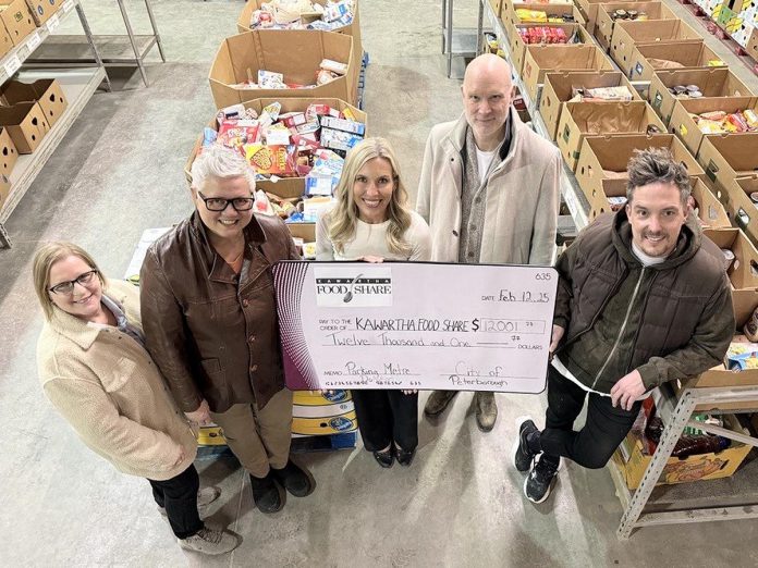 Kawartha Food Share general manager Ashlee Aitken (third from left) accepts a $12,001.77 cheque from (left to right) City of Peterborough parking operations supervisor Lynn Todd, Town Ward councillor Joy Lachica, Bill Wolfe of Wolfe Personal Injury Lawyers, and Town Ward councillor Alex Bierk at Kawartha Food Share's warehouse at 665 Neal Drive on February 12, 2025. (Photo courtesy of City of Peterborough)