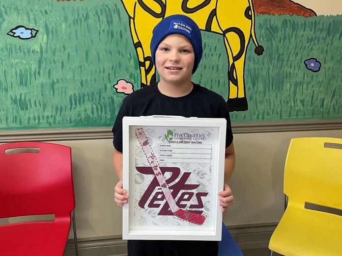 Five Counties Children's Centre staff, volunteers, and children like Kelton and their families are looking forward to attending the Peterborough Petes annual Next Gen Game on February 17, 2025 at the Peterborough Memorial Centre. Kelton's artwork was selected as the winning design to go on hundreds of miniature hockey sticks that will be available at the Family Day matinee game, which is a fundraiser for the regional children's treatment centre. (Photo courtesy of Five Counties)