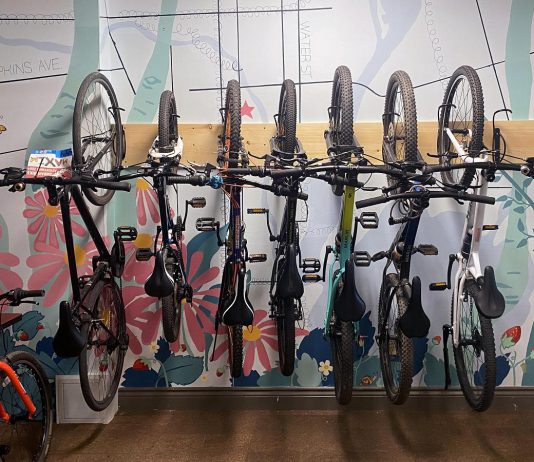 Wall hooks offer an efficient use of space when storing multiple bikes at once indoors, which are great for schools, offices, or camps. Picture above, Urban Bike Adventure campers hang their bikes in a space-conscious and attractive way in the GreenUP office in downtown Peterborough. (Photo: Natalie Stephenson / GreenUP)