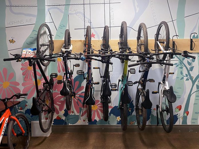 Wall hooks offer an efficient use of space when storing multiple bikes at once indoors, which are great for schools, offices, or camps. Picture above, Urban Bike Adventure campers hang their bikes in a space-conscious and attractive way in the GreenUP office in downtown Peterborough. (Photo: Natalie Stephenson / GreenUP)