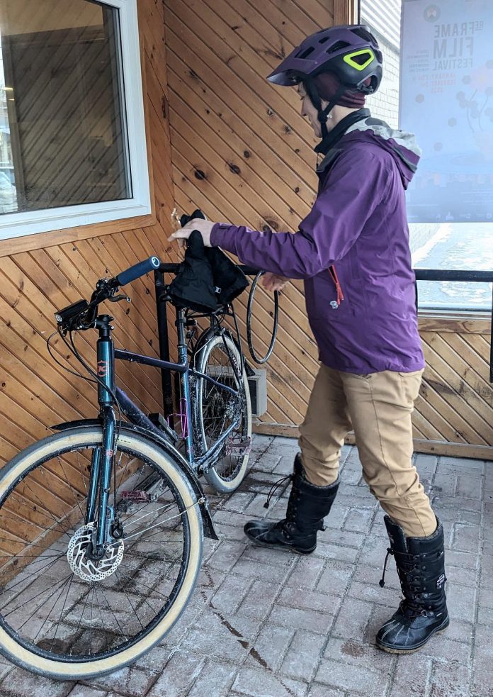 GreenUP executive director Tegan Moss parks her bike at the GreenUP office on Aylmer Street. A vestibule was converted into locked, secure bike parking for office staff which accommodates and encourages an active commute for employees. (Photo: Ashley Burnie Seeds / GreenUP)