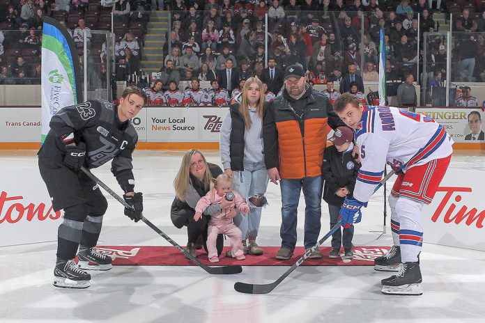 Five Counties Children's Centre client Nova (in pink) took part in the ceremonial pre-game puck drop with her family at the "Next Gen Game" at the Peterborough Memorial Centre on February 17, 2025, when the Peterborough Petes took on the Kitchener Rangers. Not only did the Petes win the game, but the annual fundraising event brought in $17,056 for Five Counties. (Photo courtesy of Peterborough Petes)