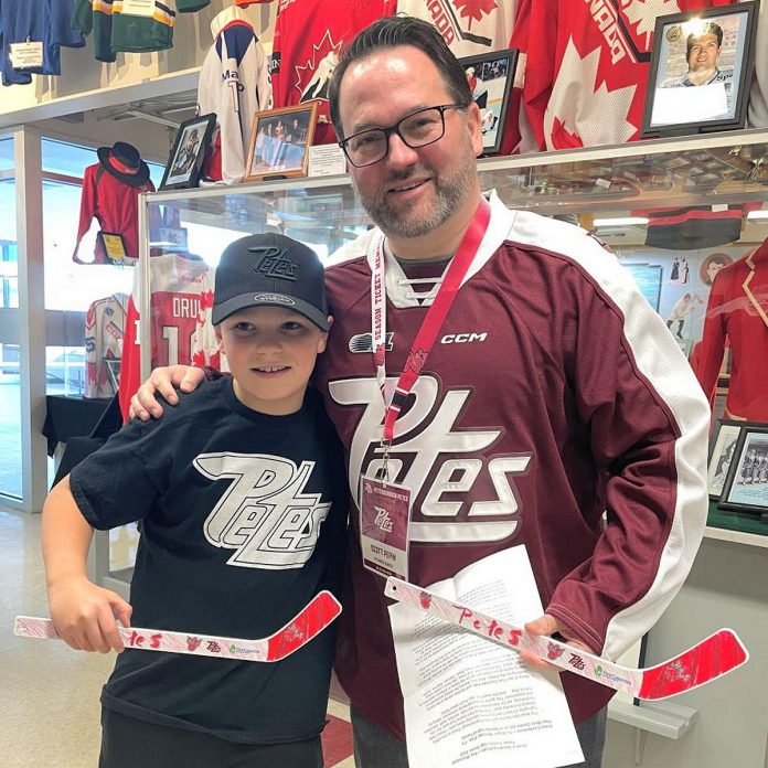 Five Counties Children's Centre client Kelton poses with CEO Scott Pepin as they hold Kelton's winning mini-stick design for the "Next Gen Game" at the Peterborough Memorial Centre on February 17, 2025. (Photo courtesy of Five Counties Children's Centre)